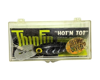 Señuelo de pesca vintage de la década de 1970, pre-Rapala Strom Thinfin Hot N Tot Deep Diver H26, con diseño de espiga negra, nuevo en su embalaje original.