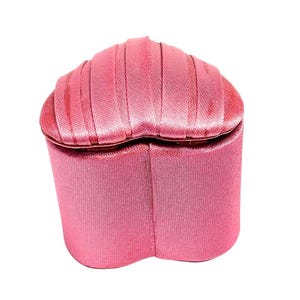 May include: A pink heart-shaped jewelry box with a satin finish.
