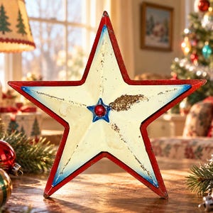May include: A five-pointed star decoration featuring a distressed cream-colored center, a red outer border, and blue accents along the inner edges. A small blue star with a red center bead is positioned at the very middle of the star ornament.