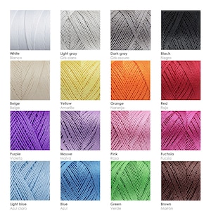 May include: A color chart of yarn skeins in various colors, including white, light gray, dark gray, black, beige, yellow, orange, red, purple, mauve, pink, fuchsia, light blue, blue, green, and brown. Each skein is labeled with the color name in both English and Spanish.
