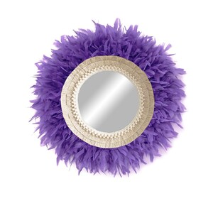 May include: A round mirror with a cream-coloured macrame frame and a purple feather trim.