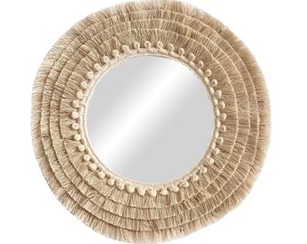 May include: A round mirror with a thick, cream-colored, woven fringe border. The fringe is made of multiple layers of thin, woven strands.