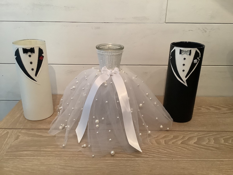 White groom with red flower , multisize pearl skirted bride, Black & White Groom