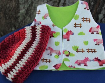 May include: A white and green baby vest with a horse print and a red and white crocheted hat.