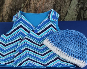 May include: A blue and white chevron patterned vest with blue buttons and a matching blue crocheted hat with a white trim.