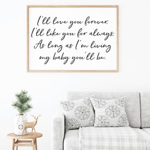 May include: A framed print with a white background and black calligraphy text that reads "I'll love you forever. I'll like you for always. As long as I'm living my baby you'll be."