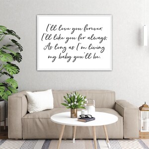 May include: A white framed print with black calligraphy text that reads "I'll love you forever. I'll like you for always. As long as I'm living my baby you'll be."
