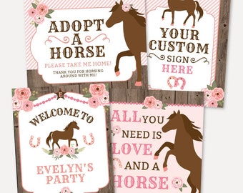 May include: Four pink and brown horse-themed party signs with floral accents. The signs read "Adopt a Horse", "Welcome to Evelyn's Party", "All You Need is Love and a Horse", and "Your Custom Sign Here".