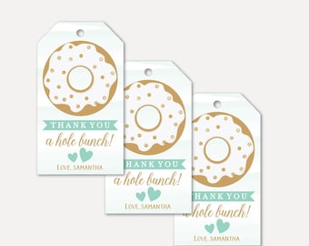May include: Three donut-shaped gift tags with a light blue watercolor background. The donuts are white with gold sprinkles and a hole in the center. The text on the tags reads "Thank you a hole bunch! Love, Samantha".
