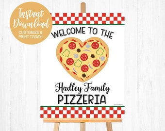 May include: A white sign with red and white checkered borders, green text that says "Welcome to the" and a heart-shaped pizza with various toppings. Below the pizza is black text that says "Hadley Family Pizzeria".
