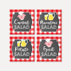May include: Four red and white checkered printable food labels with chalkboard backgrounds. Each label features a pig wearing a chef's hat and a different salad name: Caesar Salad, Macaroni Salad, Potato Salad, and Fruit Salad.