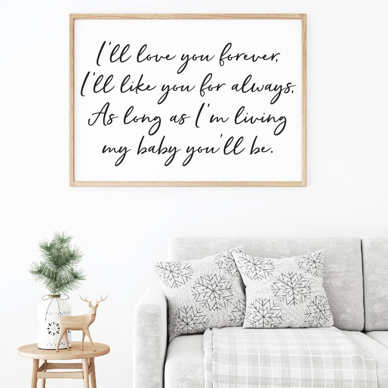 May include: A framed print with a white background and black calligraphy text that reads "I'll love you forever. I'll like you for always. As long as I'm living my baby you'll be."