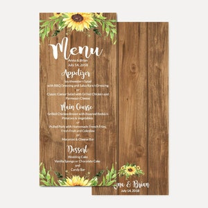 May include: A rustic wooden menu with sunflowers and greenery. The menu lists the appetizers, main course, and dessert for a wedding reception. The text reads "Menu", "Anna & Brian", "July 14, 2018", "Appetizer", "Southwestern Salad", "with BBQ Dressing and Salsa Ranch Dressing", "or", "Classic Caesar Salad with Grilled Chicken and Parmesan Cheese", "Main Course", "Grilled Chicken Breast with Roasted Redskin Potatoes & Vegetables", "or", "Pulled Pork with Homemade French Fries, Fresh Fruit and Coleslaw", "or", "Macaroni & Cheese Bar", "Dessert", "Wedding Cake", "Vanilla Sponge or Chocolate Cake", "and", "Candy Bar".