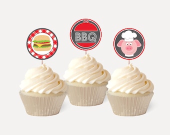 May include: Three white cupcakes with red and white checkered cupcake toppers. The toppers feature a hamburger, a pig wearing a chef's hat, and a red and white grill with the text "BBQ".