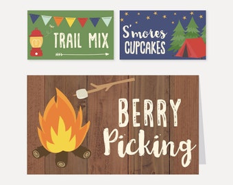 May include: Three printable food labels for a camping themed party. The labels feature a campfire with a marshmallow on a stick, a tent with stars and trees, and a lantern with the text "Trail Mix". The text on the labels reads "Berry Picking", "S'mores Cupcakes", and "Trail Mix".