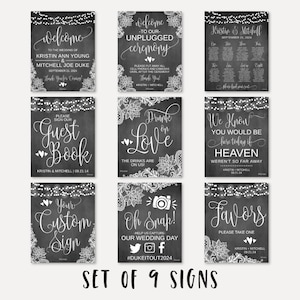 May include: Set of nine chalkboard-style wedding signs with white script and floral accents. Signs include "Welcome," "Unplugged Ceremony," "Guest Book," "Drunk on Love," "Oh Snap!," "Favors," and a seating chart. The signs are decorated with string lights.