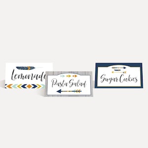 May include: Three printable food labels with a tribal theme. The labels feature a blue and gold arrow design and the text "Lemonade", "Pasta Salad", and "Sugar Cookies".
