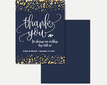 May include: Navy blue thank you card with gold confetti border. The card says "thank you" in white script with two small hearts and "for sharing our wedding day with us!"  Kristin & Mitchell | September 22, 2018