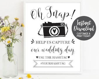 Puede incluir: Señal imprimible en blanco y negro con un gráfico de cámara y el texto "Oh Snap! Ayúdanos a capturar nuestro día de boda. Usa el hashtag #YOURHASHTAG". La señal también incluye el texto "Descarga instantánea Personaliza e imprime hoy!"