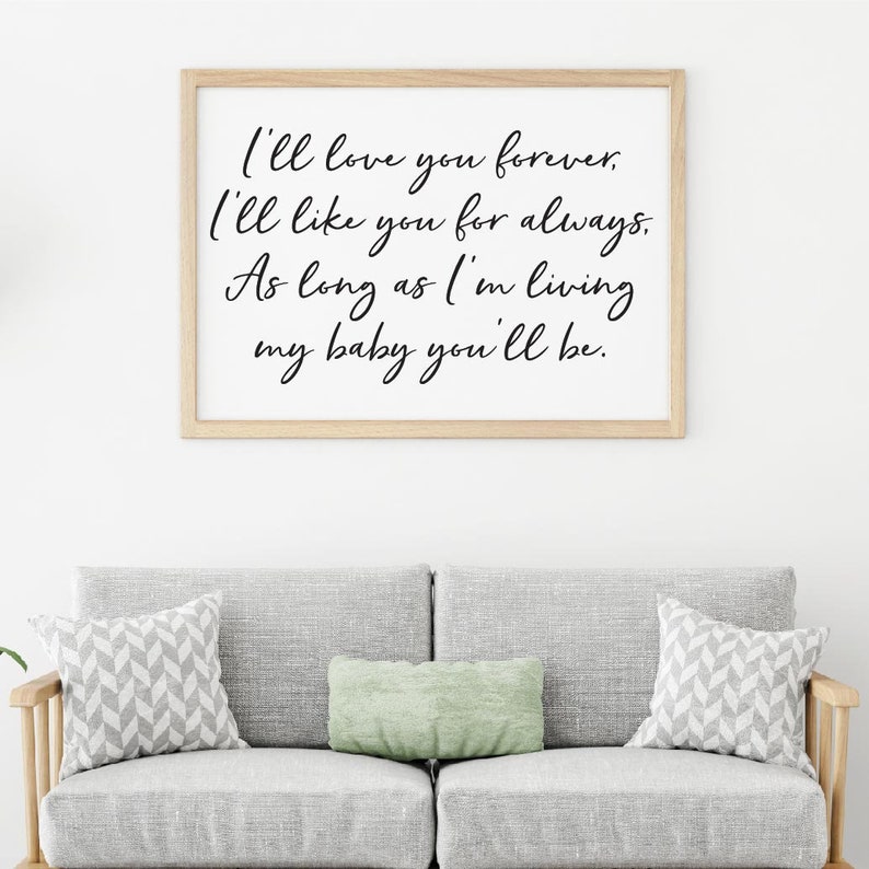 May include: A framed print with a white background and black calligraphy text that reads "I'll love you forever. I'll like you for always. As long as I'm living my baby you'll be."