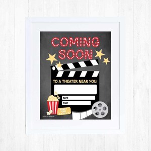 May include: A black and white chalkboard sign with the text "Coming Soon" in red letters. The sign also features a movie clapperboard, a popcorn bucket, a movie ticket, and a film reel. The text "To a Theater Near You" is written below the clapperboard. The sign also includes the words "Date" and "Time" with blank lines for filling in the information.
