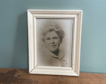 Charming old vintage sepia portrait photo of lady in painted cream frame