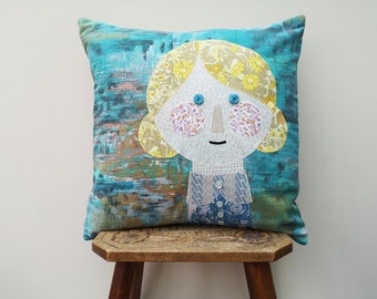 Little girl cushion cover (40cm square) made using appliqué with a variety of vintage and recycled fabrics.