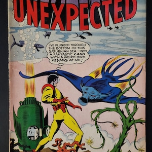 May include: Vintage comic book cover for "Tales of the Unexpected" featuring a space ranger in a yellow suit facing a large blue creature. The cover has the text "UNEXPECTED" in large red letters and the price "12¢".