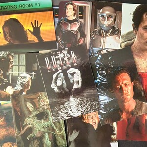 May include: A collection of rectangular trading cards featuring scenes from The Outer Limits television series. The cards display various characters, including a person behind glass labeled OPERATING ROOM #1, a metallic robot, and creatures.