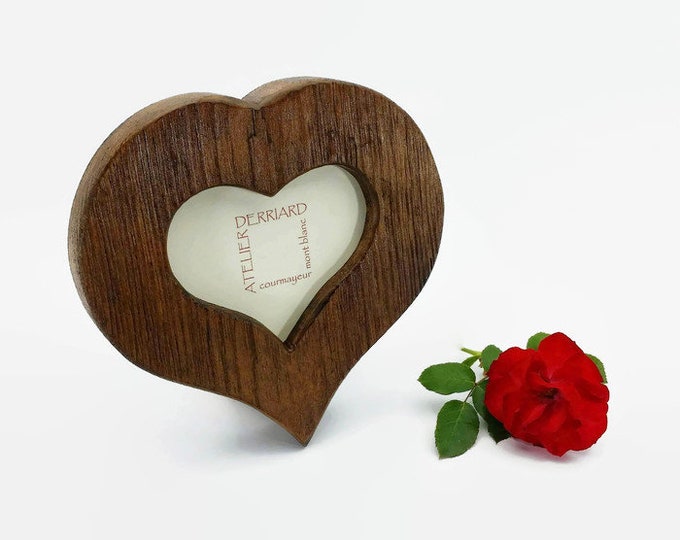 heart-shaped photo frame in old wood, table or wall