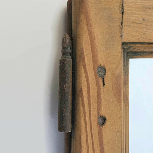 Shops framed wall mirror made with an old wooden window