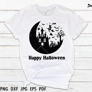 May include: White t-shirt with a black graphic of a haunted house, a witch flying on a broomstick, bats, a ghost, pumpkins, and a crescent moon. The text "Happy Halloween" is printed below the graphic.