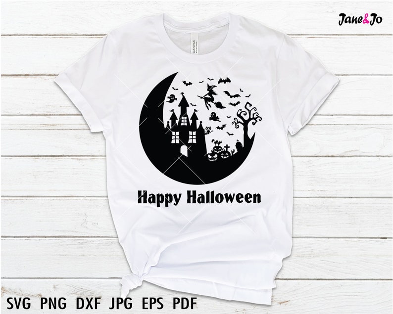 May include: White t-shirt with a black graphic of a haunted house, a witch flying on a broomstick, bats, a ghost, pumpkins, and a crescent moon. The text "Happy Halloween" is printed below the graphic.