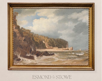 May include: A framed painting depicting a seascape with a rocky coastline, lush green trees, and a sandy beach. The sky is cloudy with a hint of blue. The painting is in a gold frame.