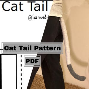May include: A digital PDF sewing pattern for a cat tail, featuring the text Cat Tail and Cat Tail Pattern. The image shows a long, two-toned tail accessory with a light grey upper section and a dark grey tip, attached to black trousers.