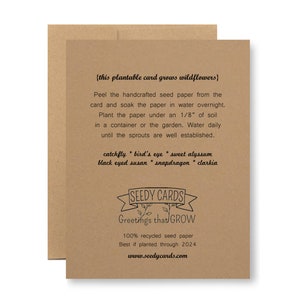May include: A brown card with the text "{this plantable card grows wildflowers}" and instructions on how to plant the seed paper. The card also includes a list of wildflowers that will grow from the paper: catchfly, bird's eye, sweet alyssum, black eyed susan, snapdragon, and clarkia. The card has a logo that says "SEEDY CARDS Greetings that GROW" and the text "100% recycled seed paper Best if planted through 2024 www.seedycards.com".