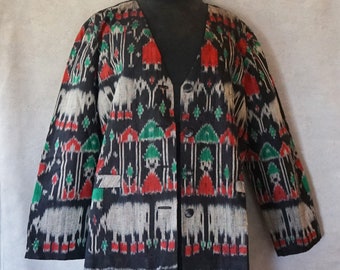 May include: A black, red, green, and white patterned jacket with a button closure. The pattern features elephants, houses, and trees.