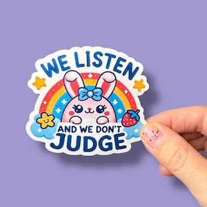 May include: A pink bunny with a blue bow is in front of a rainbow with stars. The text "We Listen and We Don't Judge" is written in blue and white.