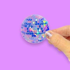 May include: A holographic sticker of a disco ball with iridescent blue, green, and purple colors.