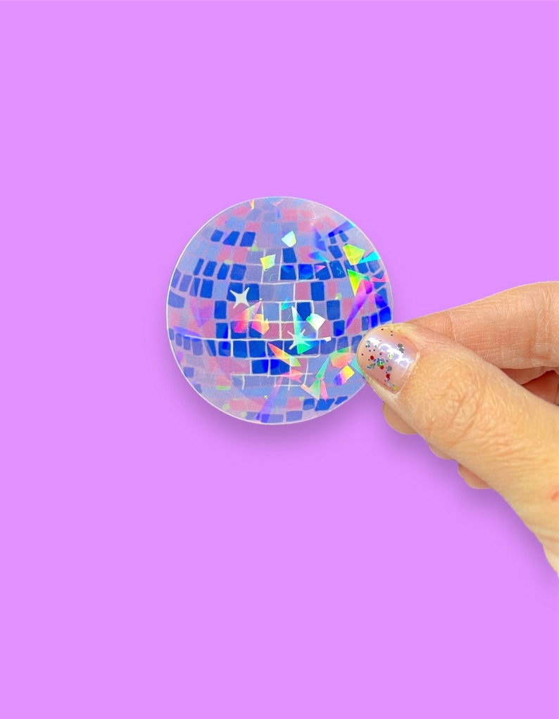 May include: A holographic sticker of a disco ball with iridescent blue, green, and purple colors.