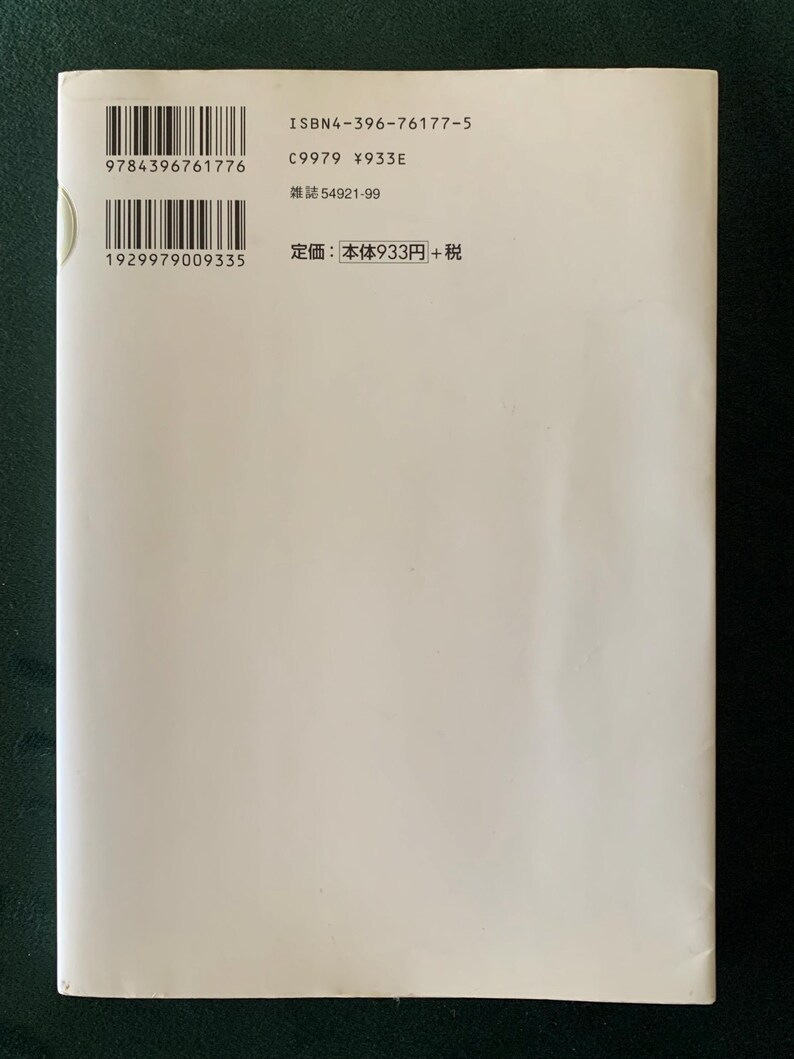 Puede incluir: Un libro blanco con texto y c&oacute;digos de barras. El texto incluye un ISBN, un precio y otros caracteres japoneses. El libro tiene un c&oacute;digo de barras en el lado izquierdo y una serie de n&uacute;meros y texto en el lado derecho.