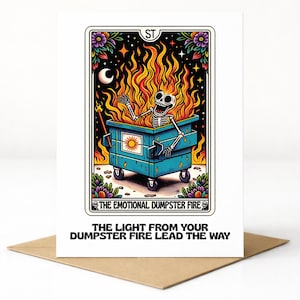 May include: A greeting card featuring a skeleton engulfed in flames inside a blue dumpster. The card reads "THE EMOTIONAL DUMPSTER FIRE" and "THE LIGHT FROM YOUR DUMPSTER FIRE LEAD THE WAY". The card is on a brown envelope.