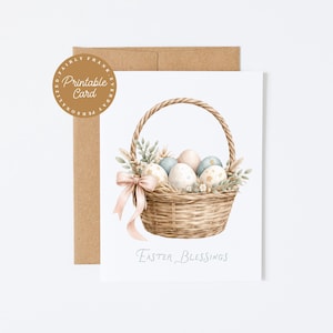 May include: A watercolor illustration of an Easter card featuring a woven basket filled with decorated eggs and greenery. A pink bow adorns the basket. The card is accompanied by a brown envelope and a round sticker that says "Printable Card". The words "Easter Blessings" are written below the basket.