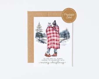 May include: A watercolor Christmas card featuring a couple wrapped in a red and white plaid blanket, standing in a snowy landscape. The card includes the text "To the one I'll always choose to adventure with merry christmas."