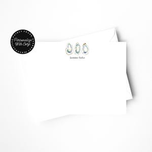 May include: White stationery set featuring three watercolor oyster illustrations. The text "Jasmine Parks" is printed below the illustrations. A black circular sticker with the text "Personalize With Caryl" is in the upper left corner.