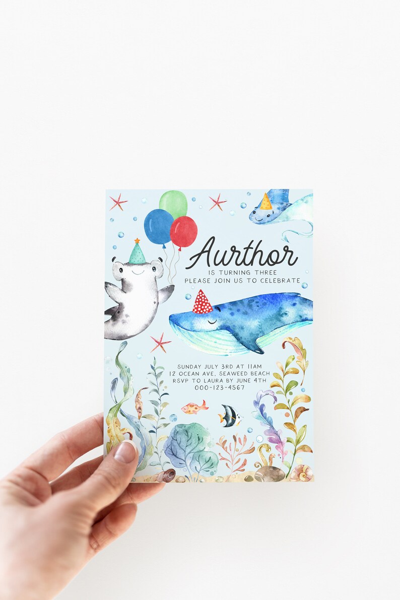 May include: A blue and white invitation card with a watercolor illustration of a whale, a hammerhead shark, and a starfish. The text on the card reads "Aurthor is turning three. Please join us to celebrate. Sunday July 3rd at 11am. 12 Ocean Ave, Seaweed Beach. RSVP to Laura by June 4th. 000-123-4567."