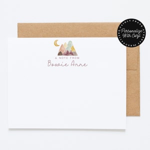 May include: A white note card with a watercolor illustration of mountains and a crescent moon. The text "A Note From Bowie Anne" is printed in purple below the illustration.