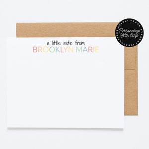 May include: A white card with a brown envelope. The card has the text "a little note from BROOKLYN MARIE" in rainbow colors.