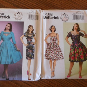 May include: Two sewing pattern envelopes for dresses. The left envelope is for Butterick pattern B6590 and features a turquoise dress with a sweetheart neckline. The right envelope is for Butterick pattern B6556 and features three dresses: a white dress with red floral print, a black dress with pink floral print, and a blue dress with pink floral print.