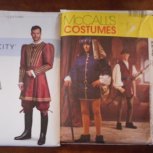 May include: Two vintage costume pattern envelopes. The Simplicity pattern features a Renaissance-style outfit in burgundy and gold. The McCall's pattern shows a medieval costume in blue and gold. Both patterns display illustrations of the costumes.